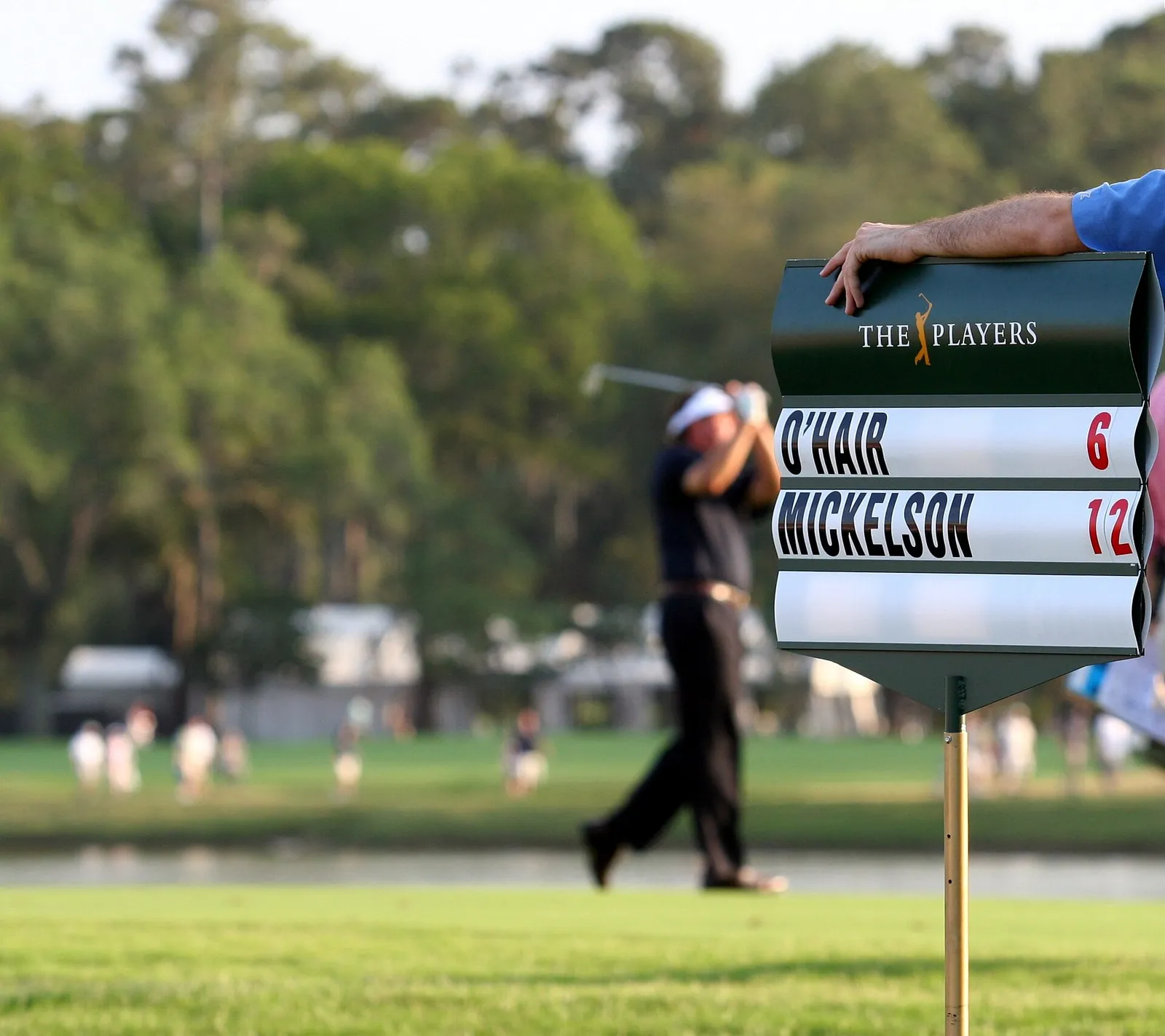 Golfspelare i sving på en fairway