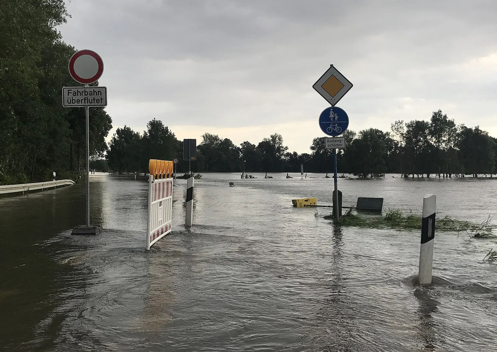 Avstängd väg täckt av översvämningsvatten